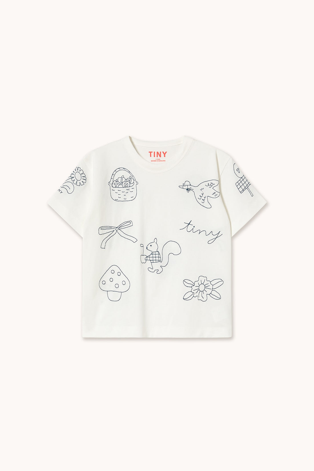 A white short-sleeve kids' t-shirt by TINY brand, featuring light gray line art illustrations of a basket, dragonfly, bird, squirrel, mushroom, flower, and the word 'tiny' on the front.